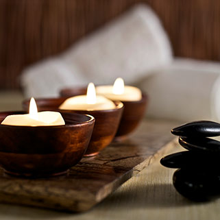 lit candles and massage stones